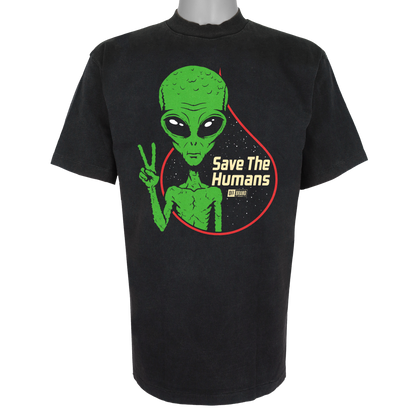 Save The Humans parody t-shirt featuring a green alien holding up a peace sign in front of a starry background on a Vintage Black garment.